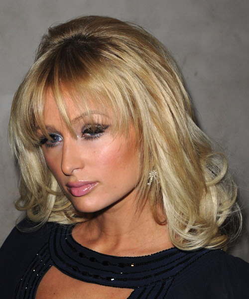 Paris Hilton Long Wavy    Golden Blonde   Hairstyle with Layered Bangs - side on view