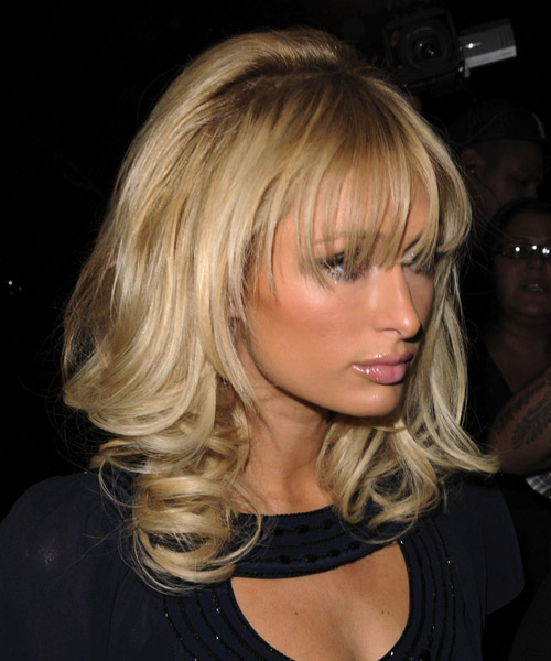 Paris Hilton Long Wavy    Golden Blonde   Hairstyle with Layered Bangs - side view